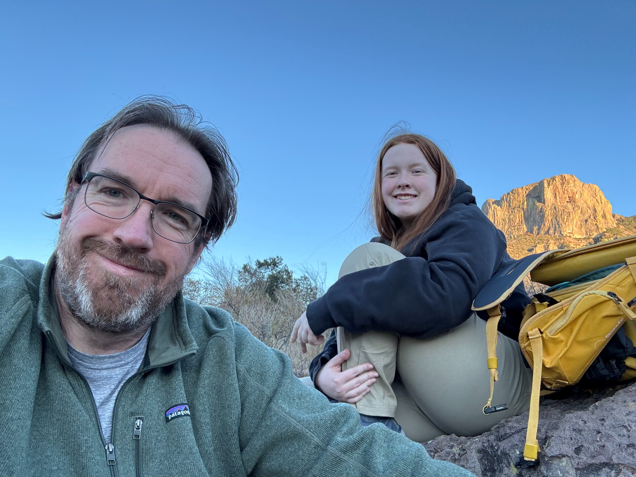 Cameron and I both sitting down in the desert waiting for sunset.