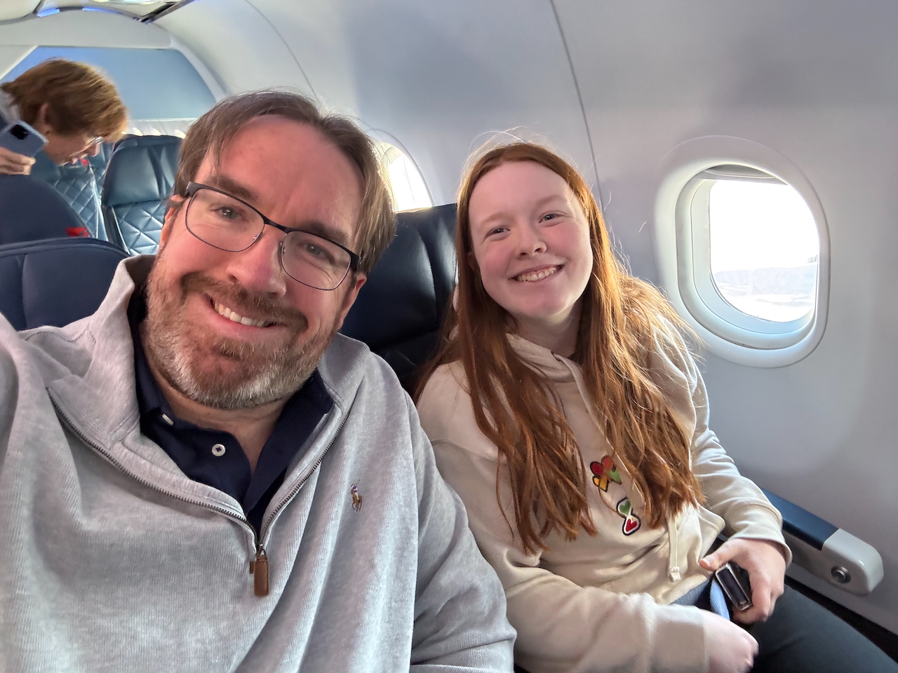 Cameron and Chris (myself) taking a selfie sitting in First Class on a Delta Airlines Flight heading from Boston to Oregon.