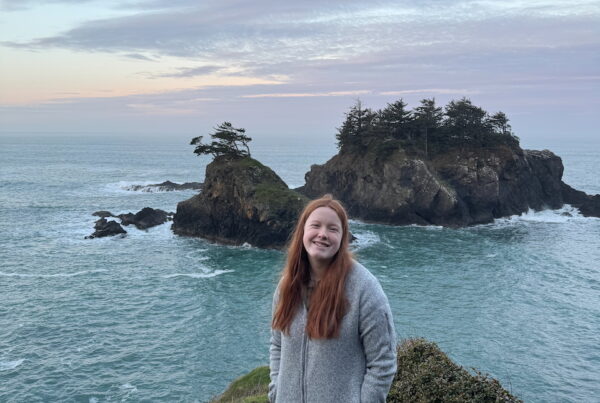 Cameron at sunset with clouds in the sky and a few islands right behind her at the Thunder Rock View Point.