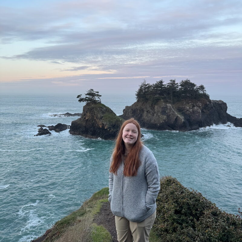 Cameron at sunset with clouds in the sky and a few islands right behind her at the Thunder Rock View Point.