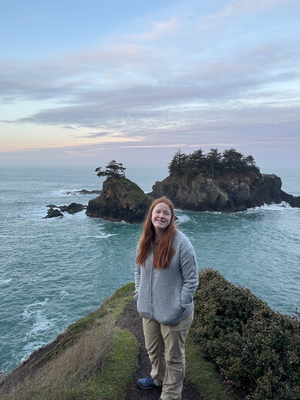 Cameron at sunset with clouds in the sky and a few islands right behind her at the Thunder Rock View Point.