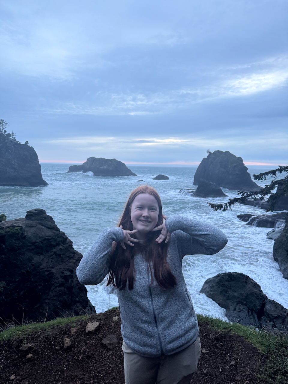 Cameron posing for a photo at the end of sunset at Secret Beach.