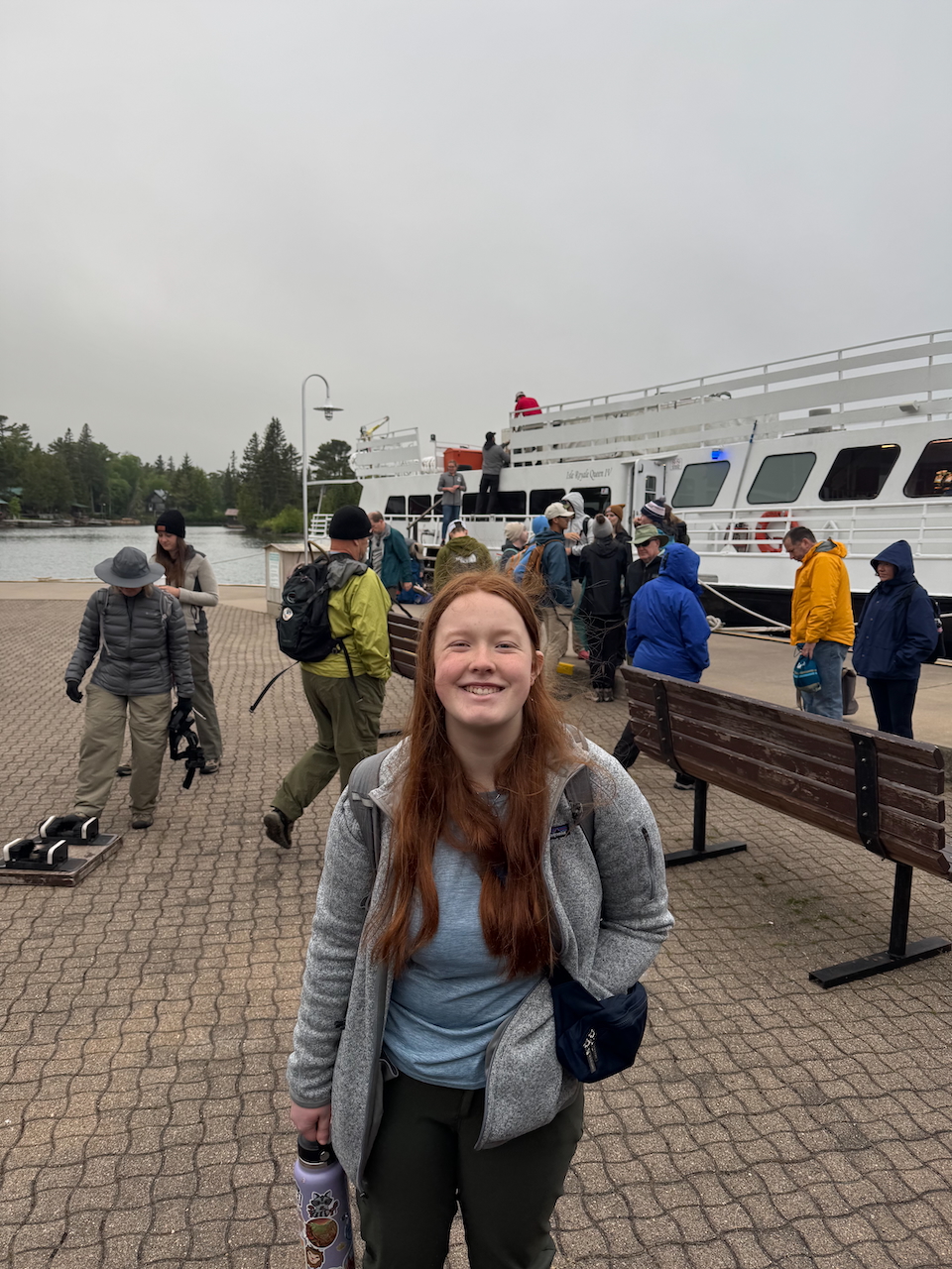 Cameron with her hiking cloths on, a big smile while standing on the docks at Harbor Bay getting ready to board the Queen IV.