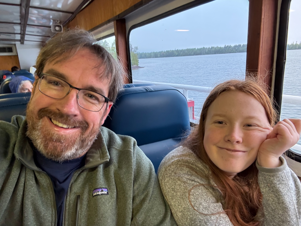 Cameron and myself with smiles on our face, sitting by the window as we get underway to Isle Royal on the Queen IV.