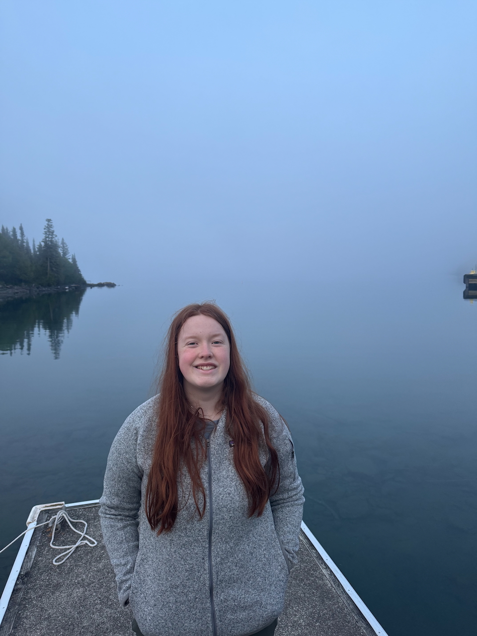 Cameron standing by the dock at Sunrise in Rock Harbor. The fog has come in and you can hardly see anything.