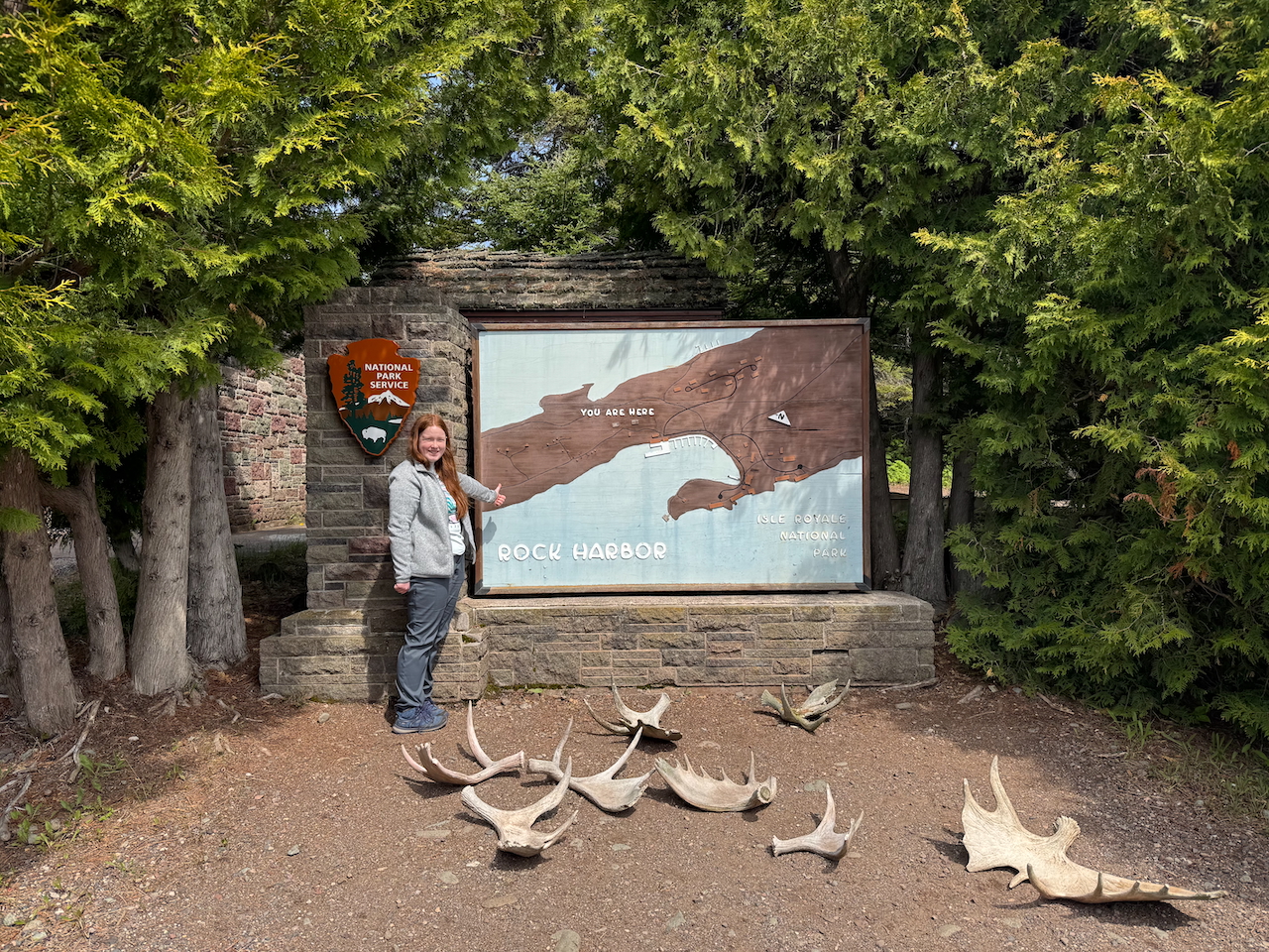 Cameron standing in front of the Isle Royale National Park Sign.