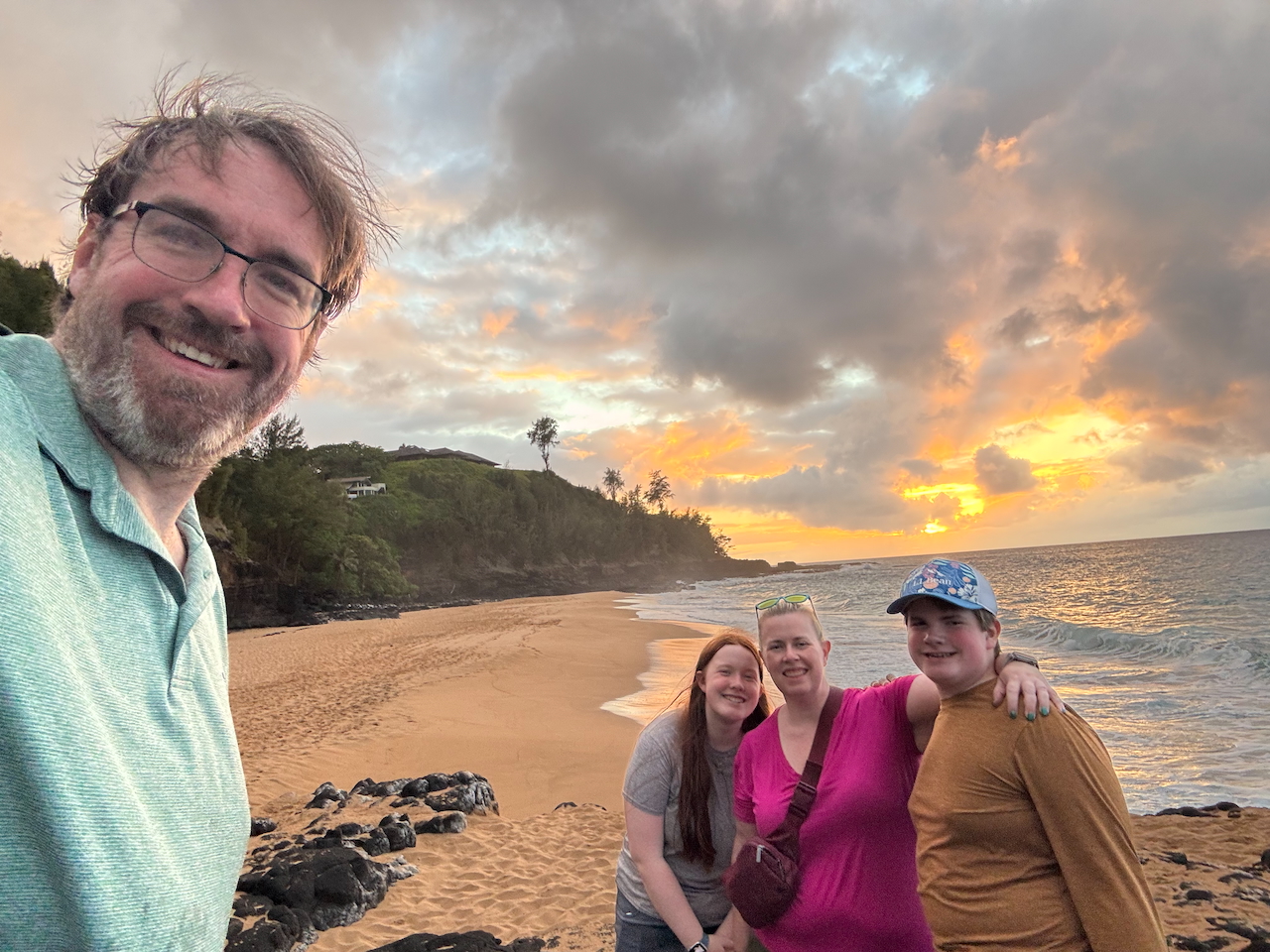 Chris, Cat, Collin, and Cameron at Secret Beach with a glowing sunset sky.