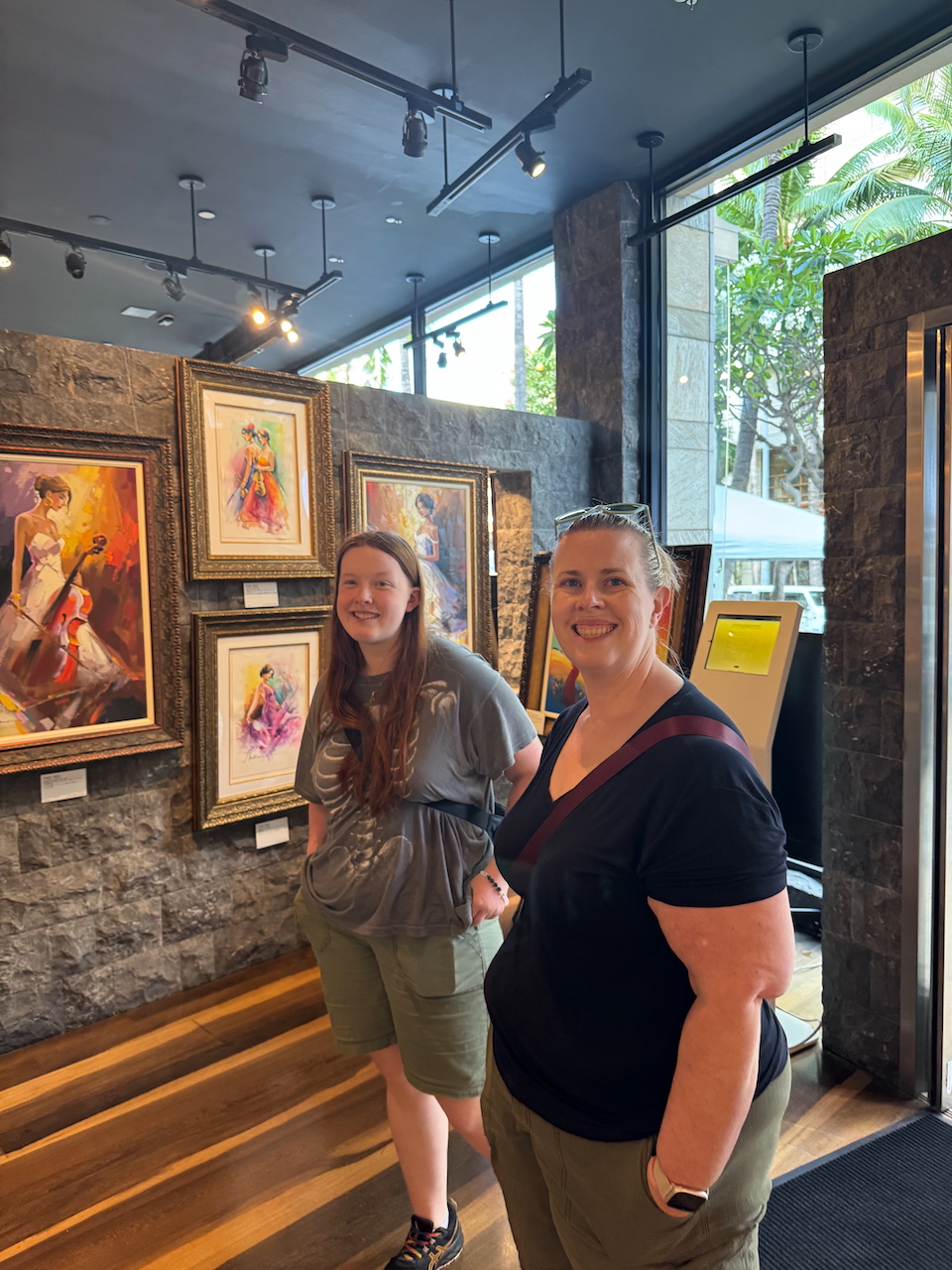 Cat and Cameron browsing artwork in a Waikīkī gallery.