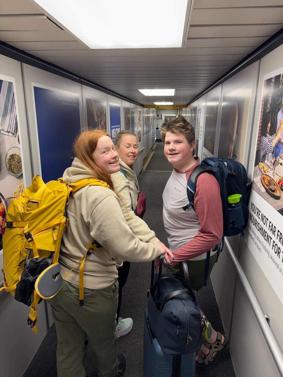 Family boarding plane with backpacks.