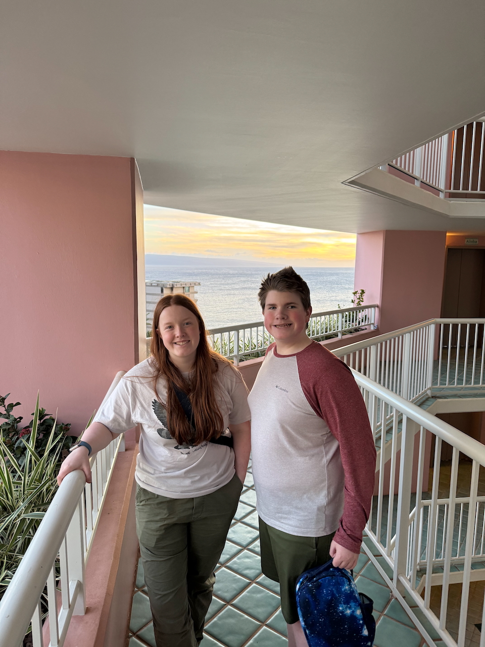 Cameron and Collin at hotel balcony with sunset.