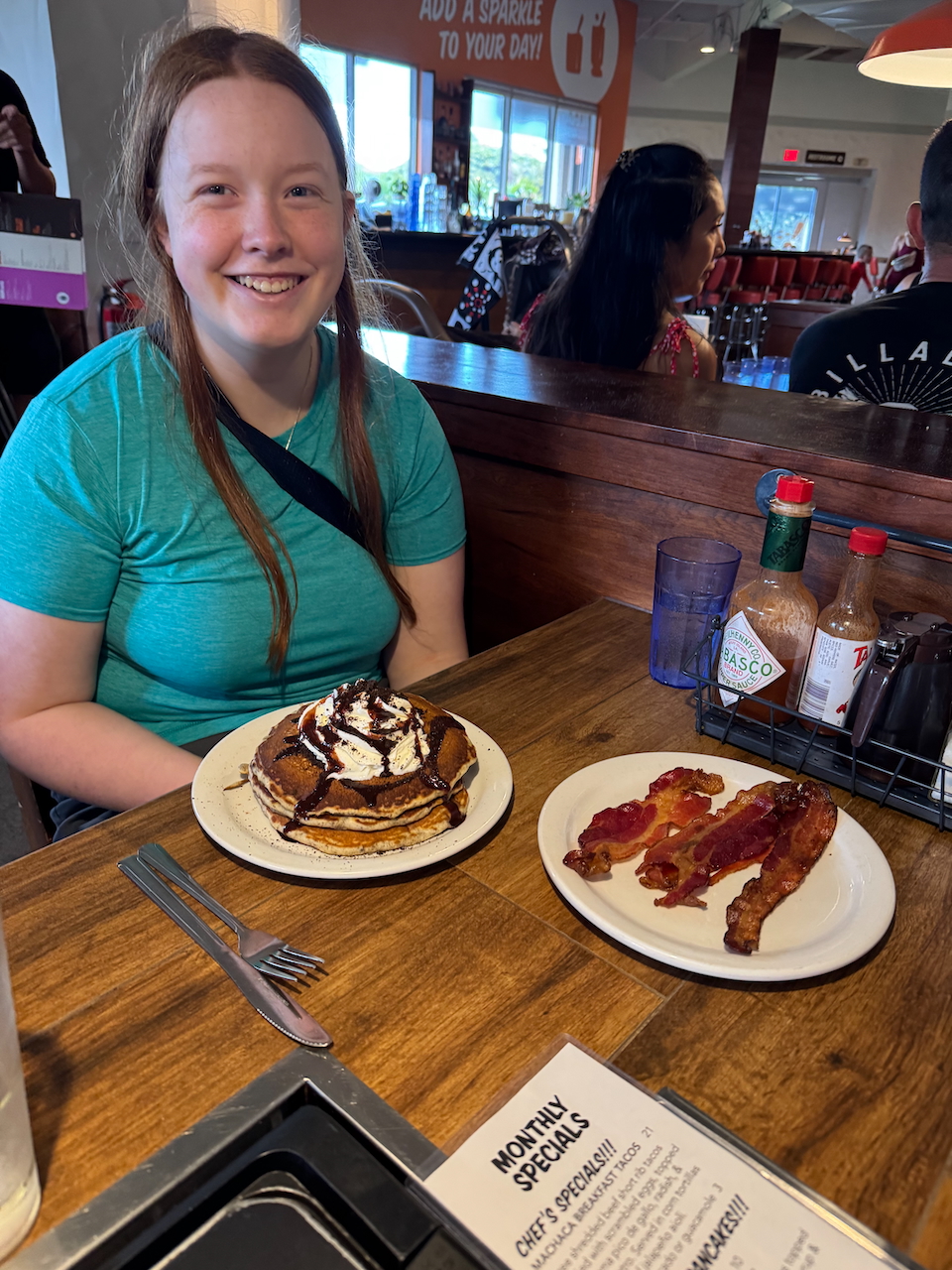 Cameron with pancakes and bacon breakfast.
