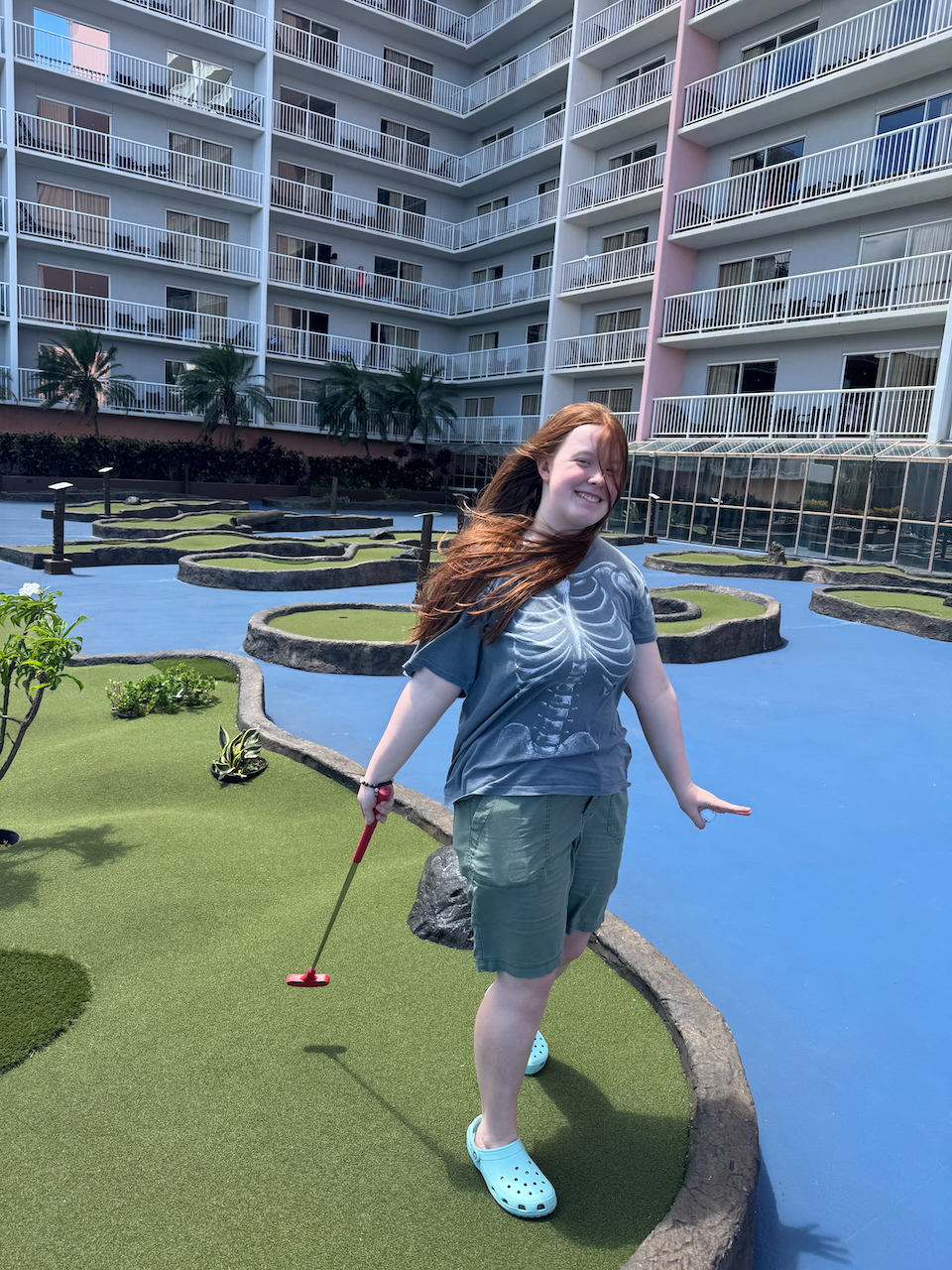 Cameron playing mini golf at Hilton Grand Vacations.