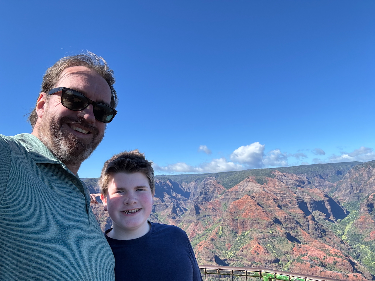 Chris and Collin smiling at Waimea Canyon Lookout.