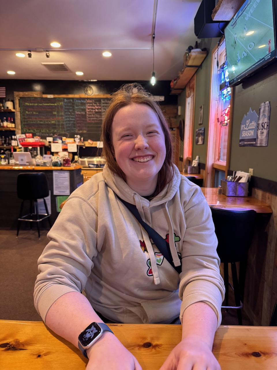 Cameron sitting inside The Blind Pig restaurant in International Falls, smiling at the table.