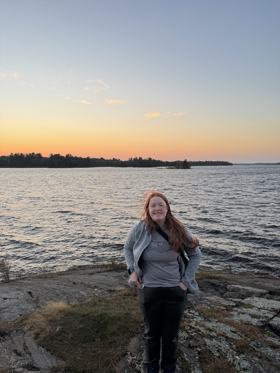 Cameron standing by the lake at the Ash River area in Voyageurs National Park at dusk.