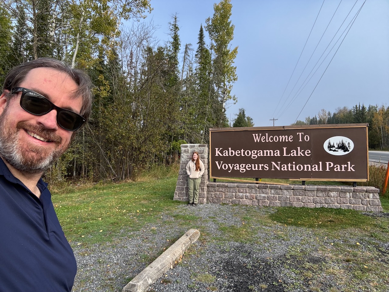 Chris standing by the “Welcome to Kabetogama Lake – Voyageurs National Park” sign.