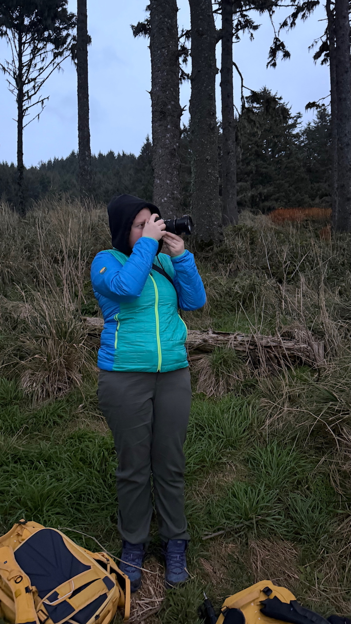 Cameron near Heceta Head Lighthouse at sunrise on the Oregon Coast taking a photo