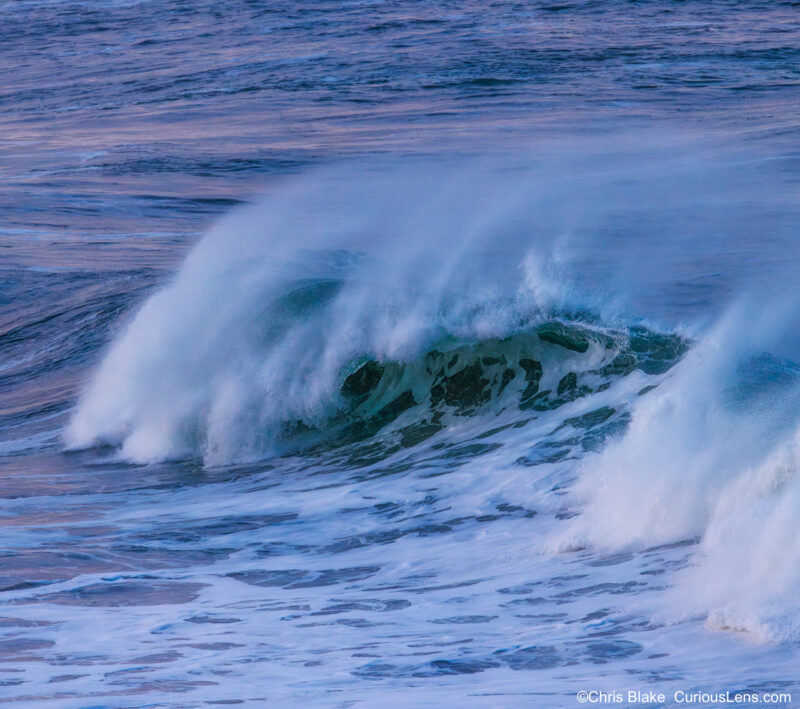 Morning surf near Heceta Head Lighthouse with soft sunrise light reflecting on the water
