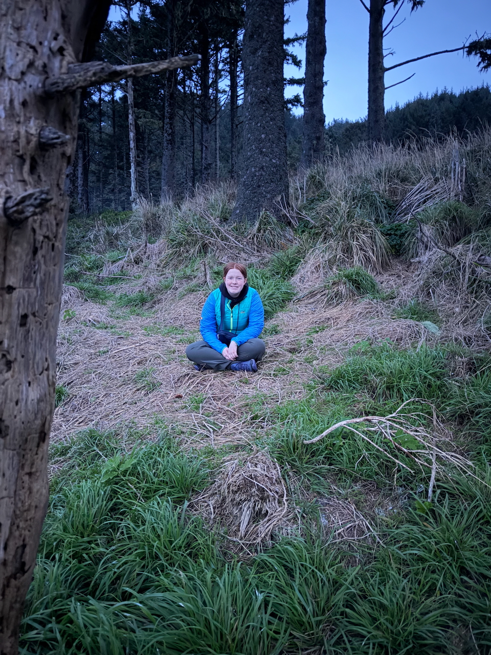 Cameron sitting quietly while waiting for sunrise on the Oregon Coast