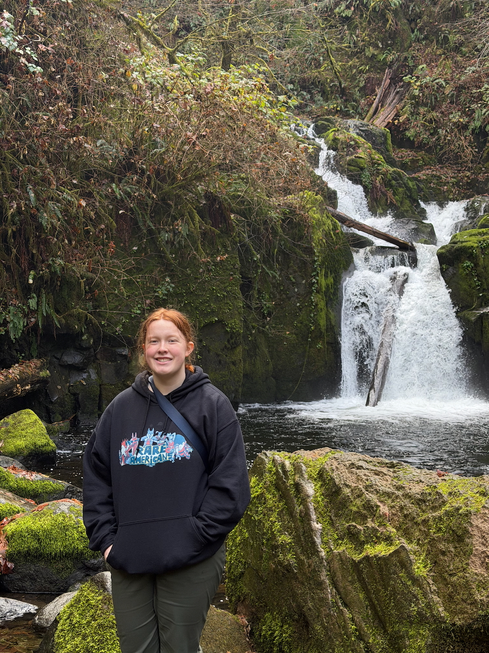 Cameron standing near the main waterfall at Sweet Creek Falls in Oregon