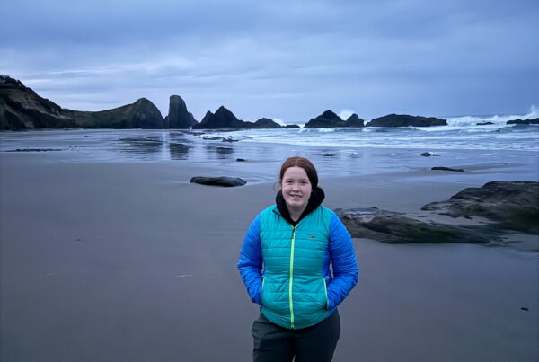 Cameron standing at Seal Rock before sunrise on the Oregon Coast
