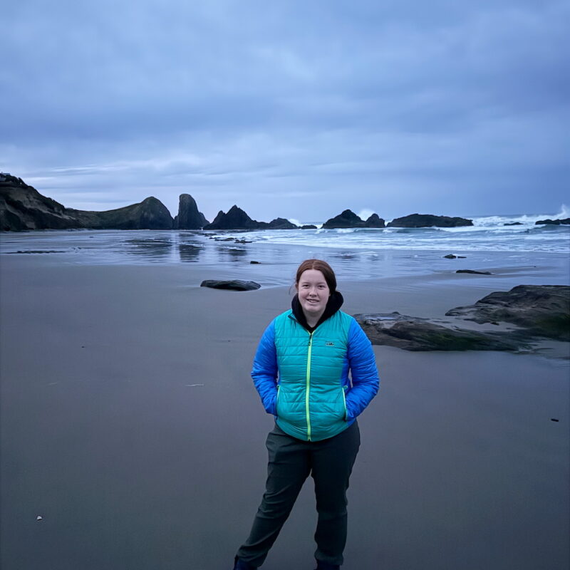 Cameron standing at Seal Rock before sunrise on the Oregon Coast