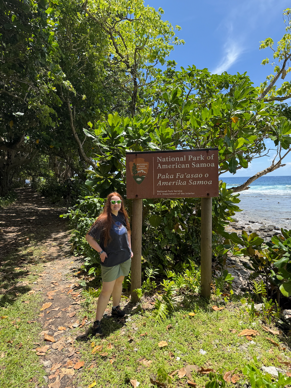 Cameron standing by the National Park of American Samoa sign.
