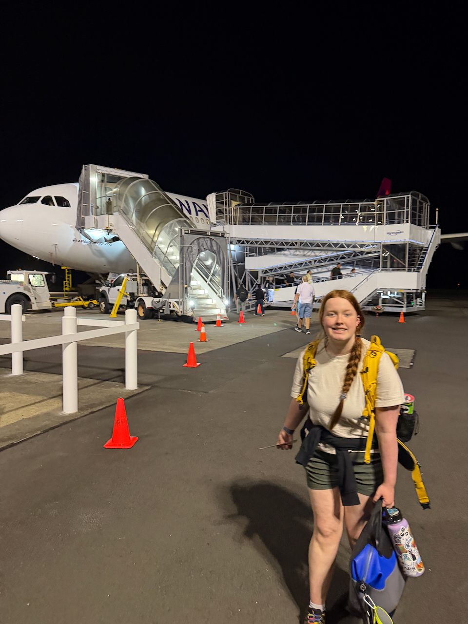 Cameron walking to the Hawaiian Airlines plane in Pago Pago.
