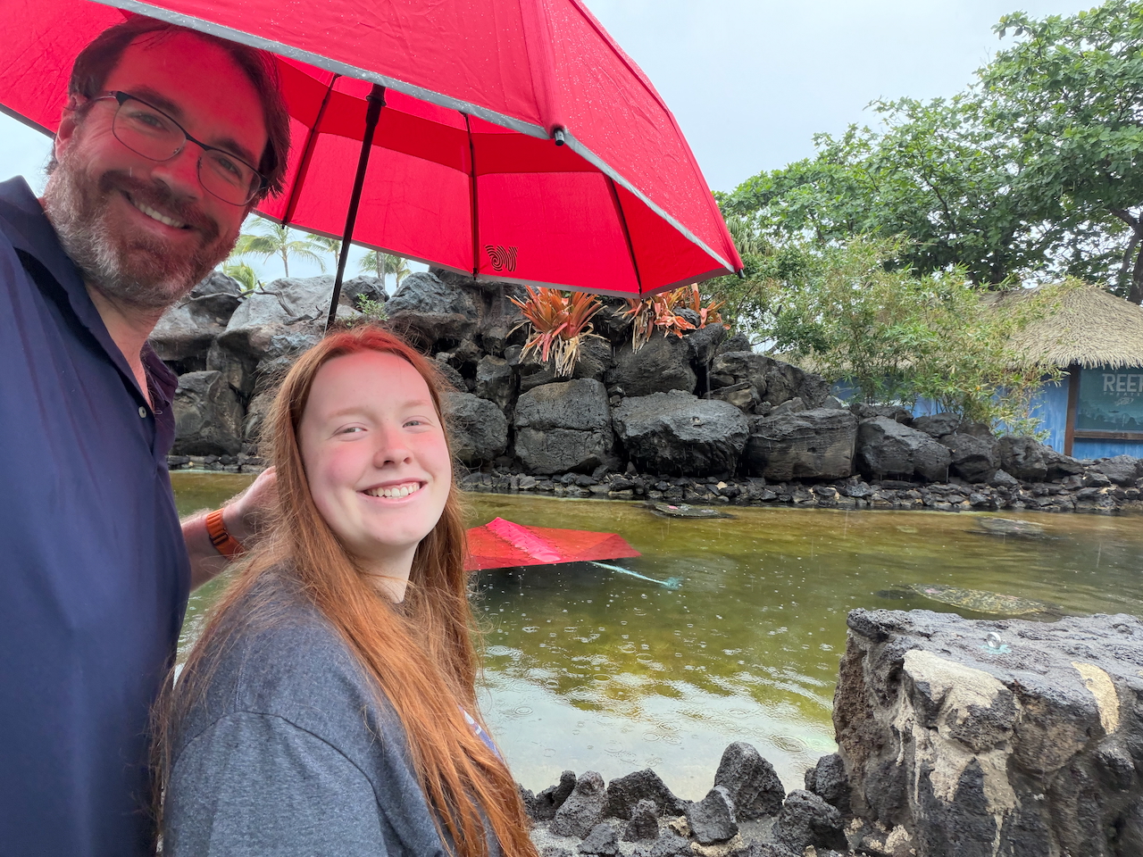 Chris and Cameron in the rain at Sea Life Park Hawaii.
