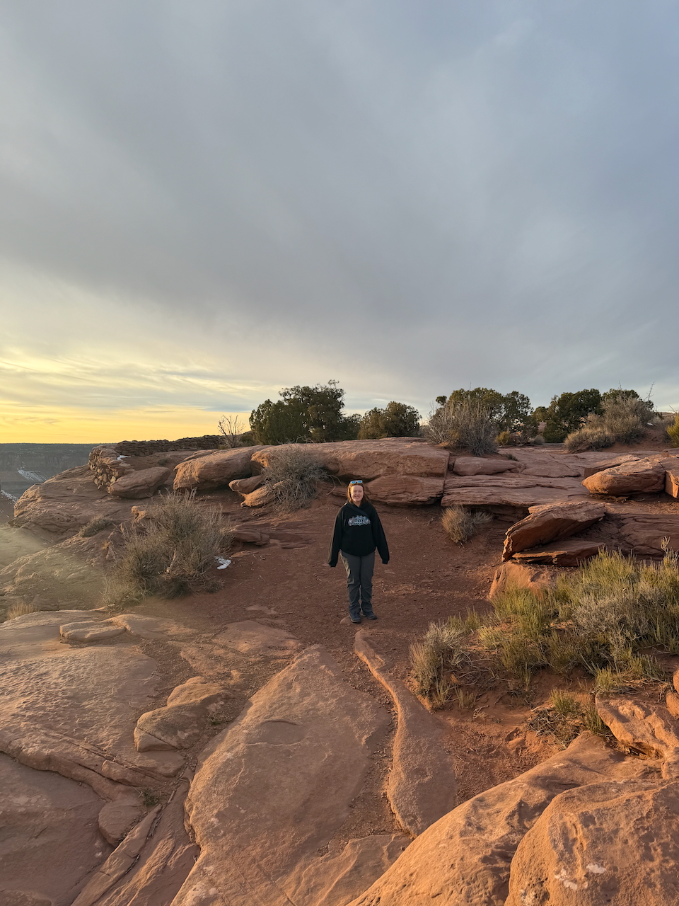 Cameron hiking through Dead Horse Point State Park at sunset.