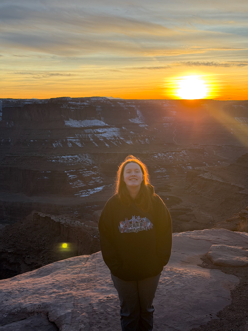 Cameron at sunset in Dead Horse Point State Park with snow in the distance.