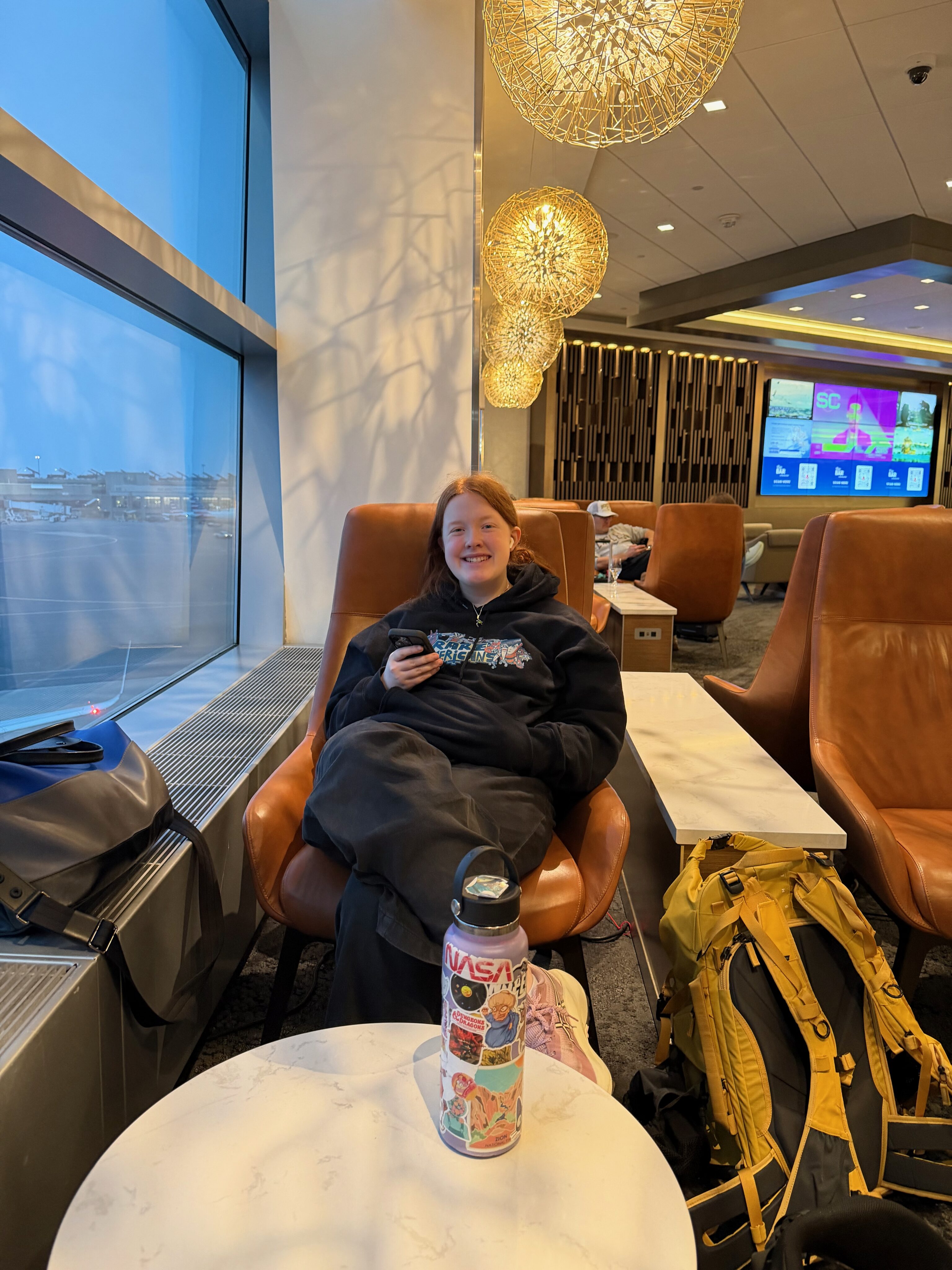 Cami relaxing in the Delta Sky Club at Boston Logan Airport before flying to Seattle.