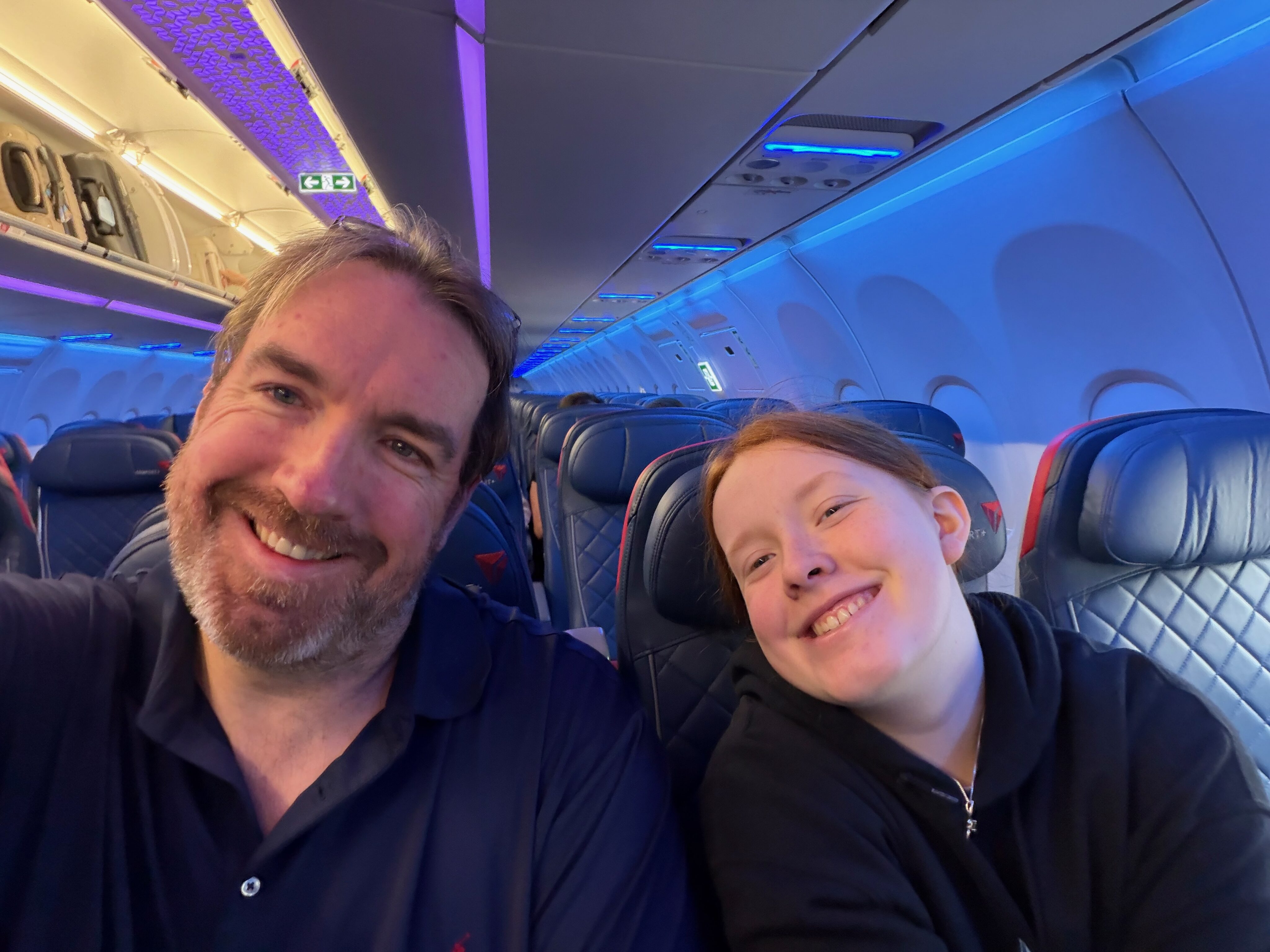 Chris and Cami sitting together on a Delta flight to Seattle.