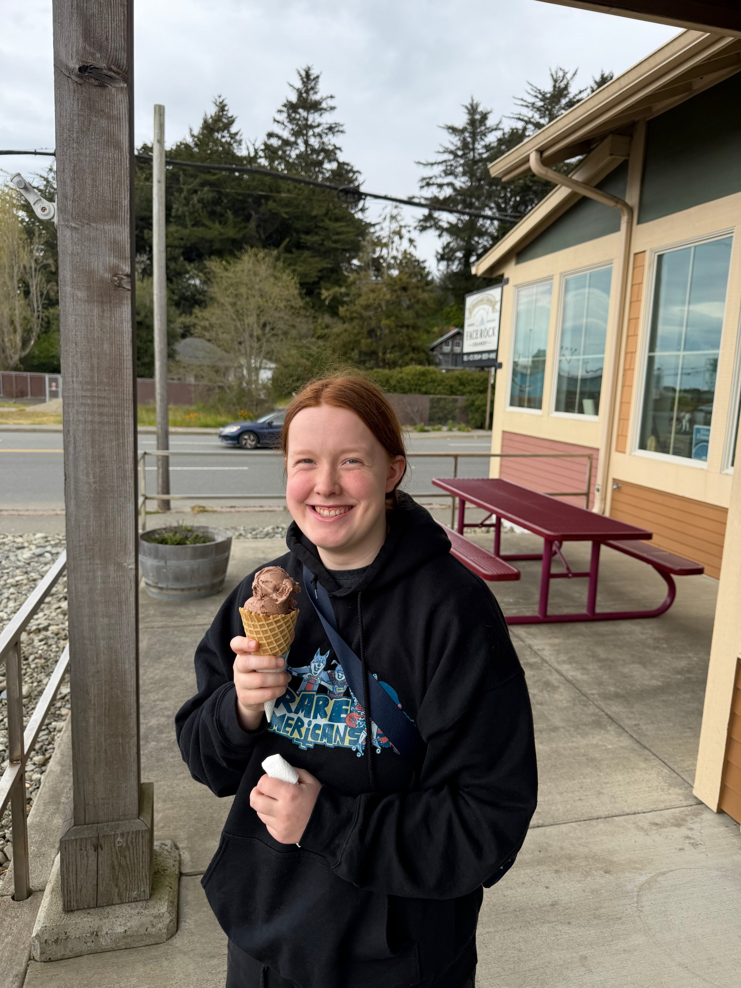 Cami holding an ice cream cone outside Face Rock Creamery in Bandon, Oregon.