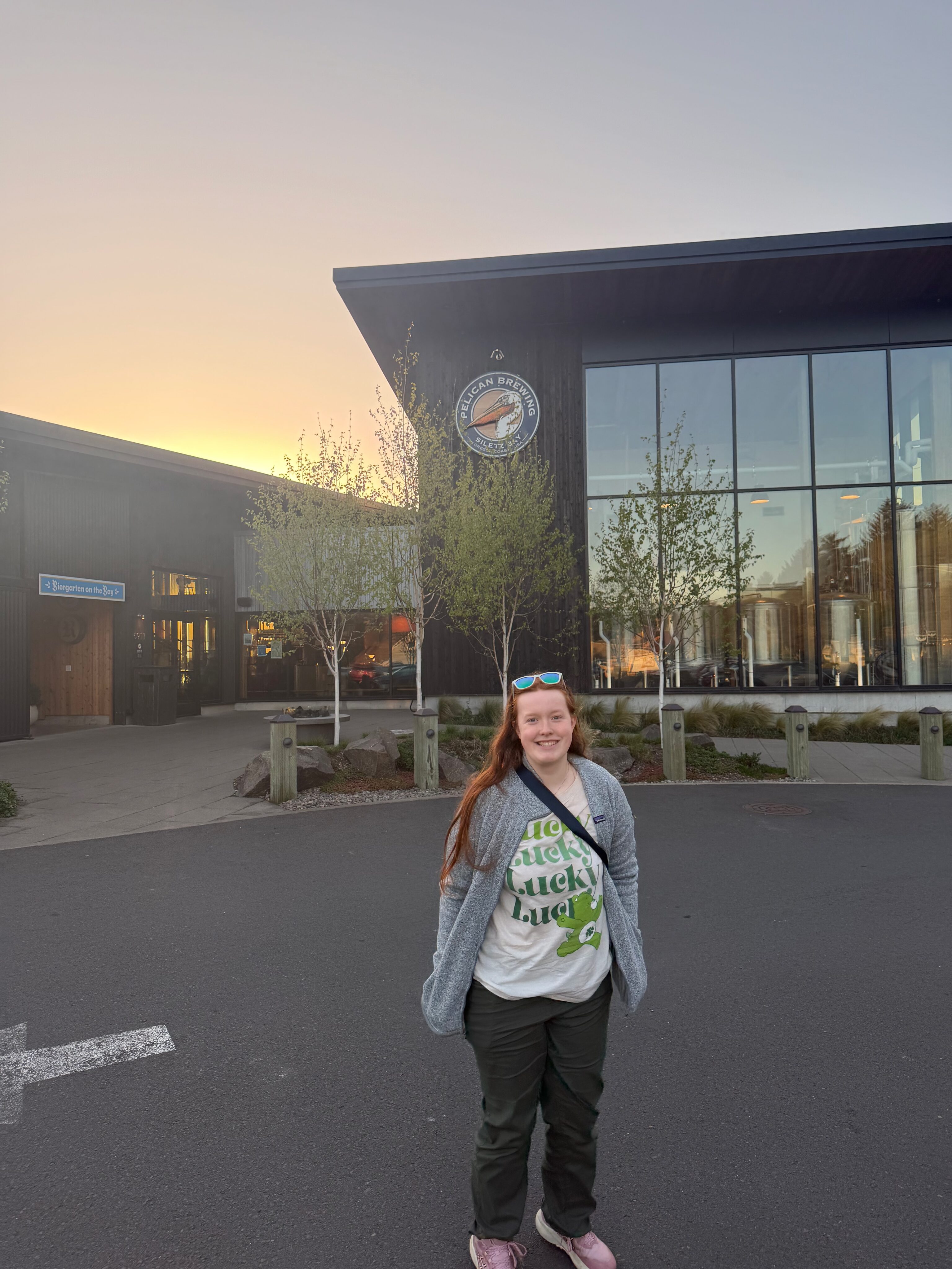 Cami standing outside Pelican Brewing on the Oregon Coast.