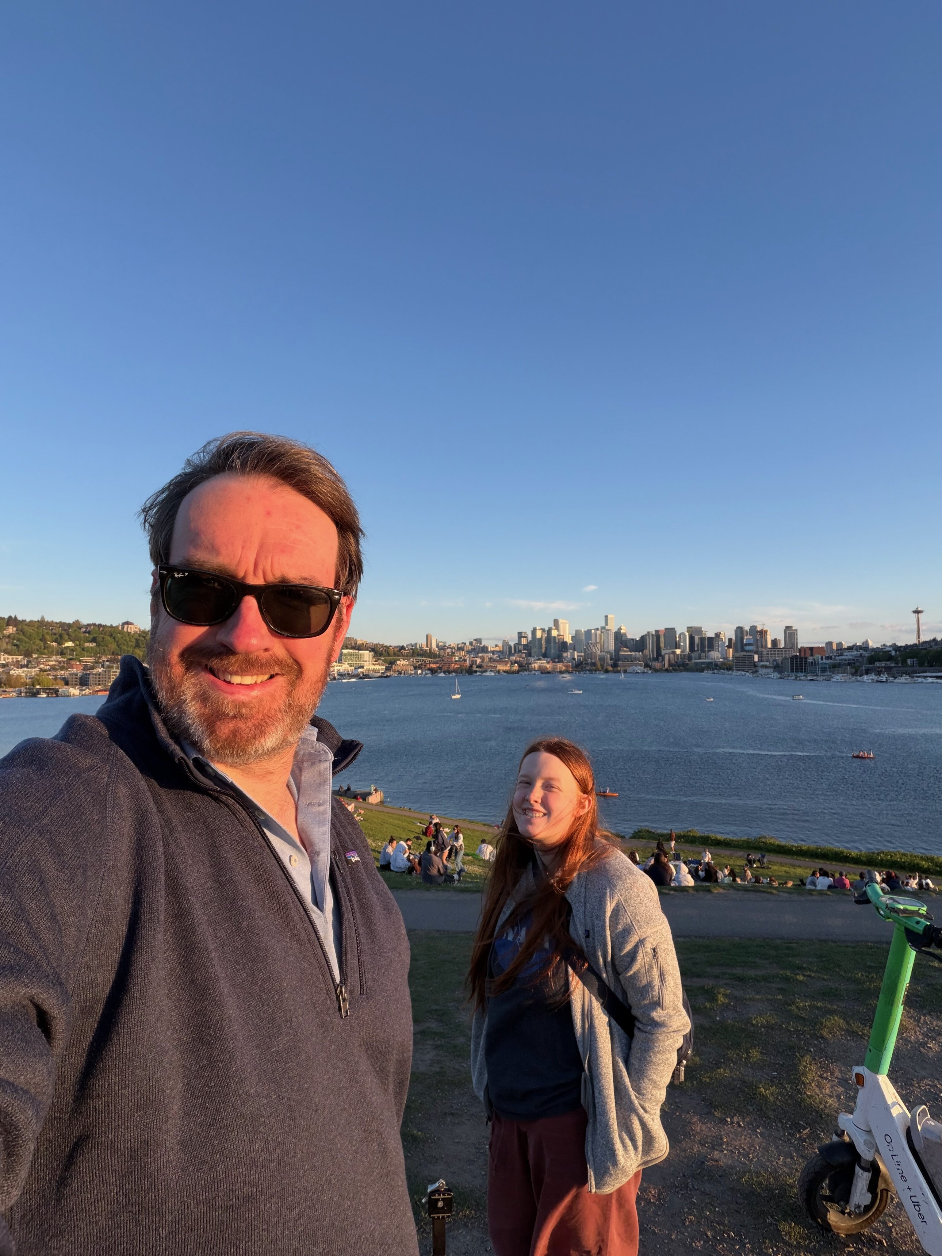 Chris and Cami taking a selfie at Gas Works Park with the Seattle sunset behind them.
