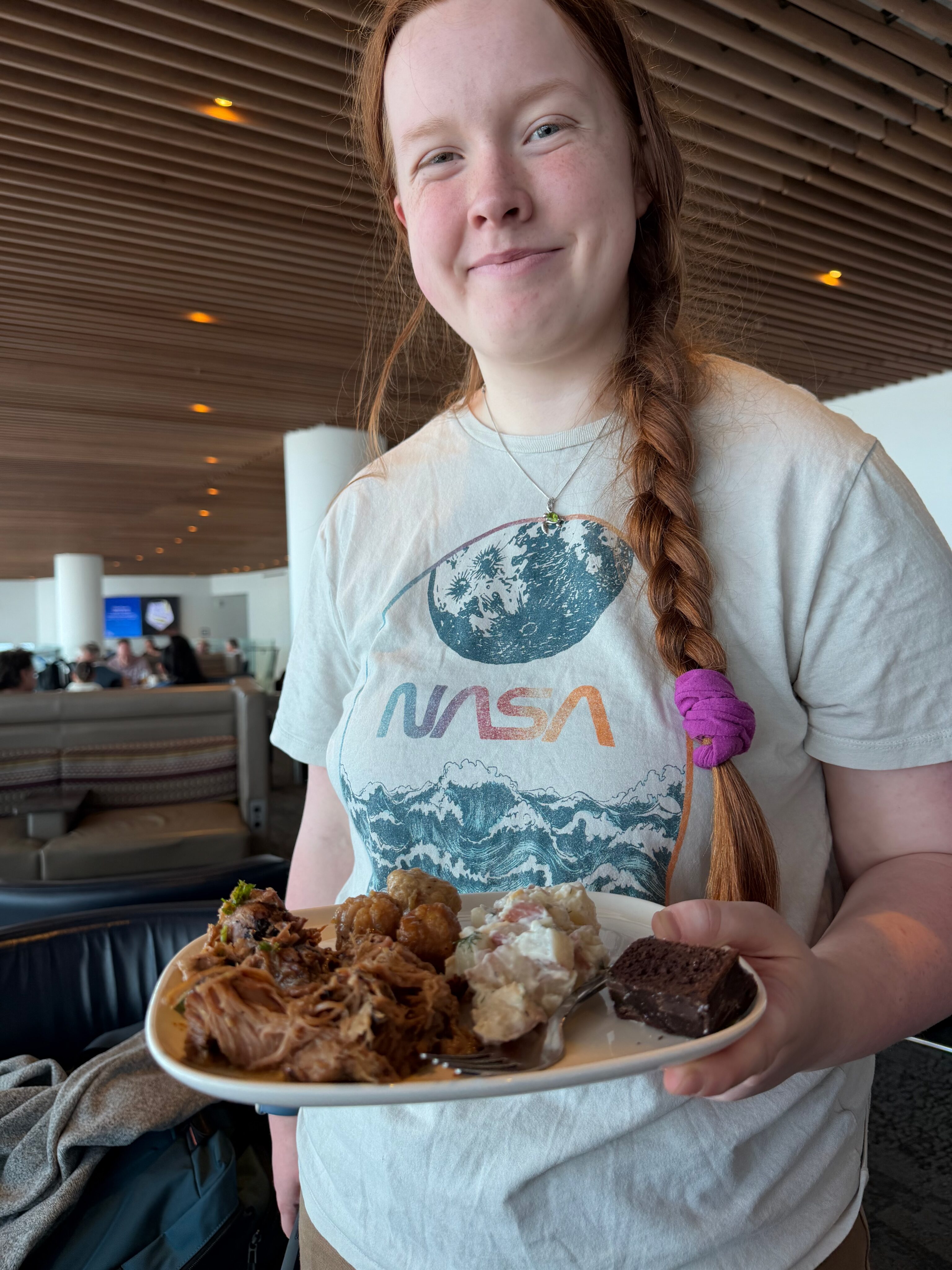 Cami holding breakfast in the Delta Sky Club at Seattle-Tacoma International Airport.