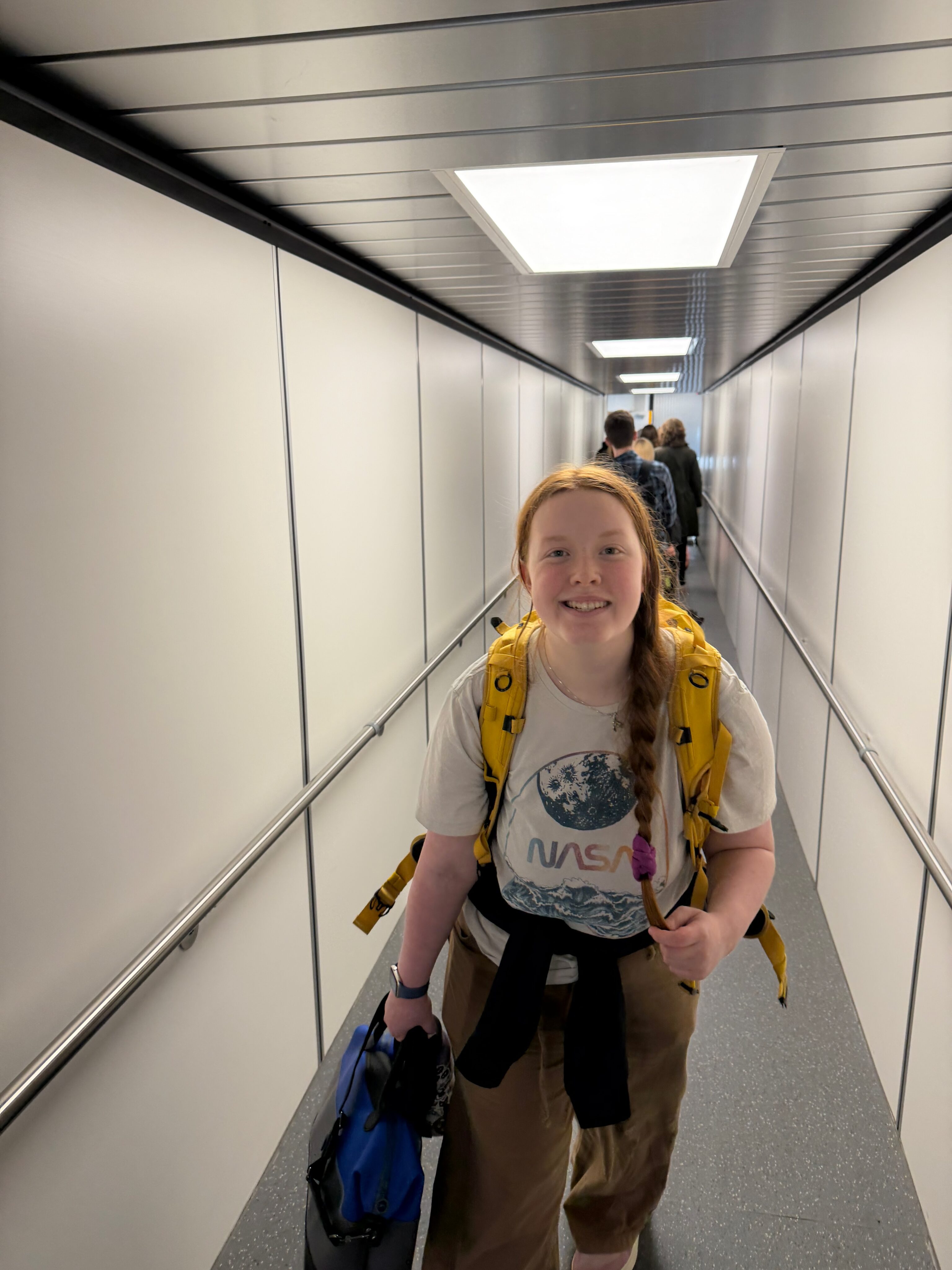 Cami walking down the jet bridge to board the flight home.